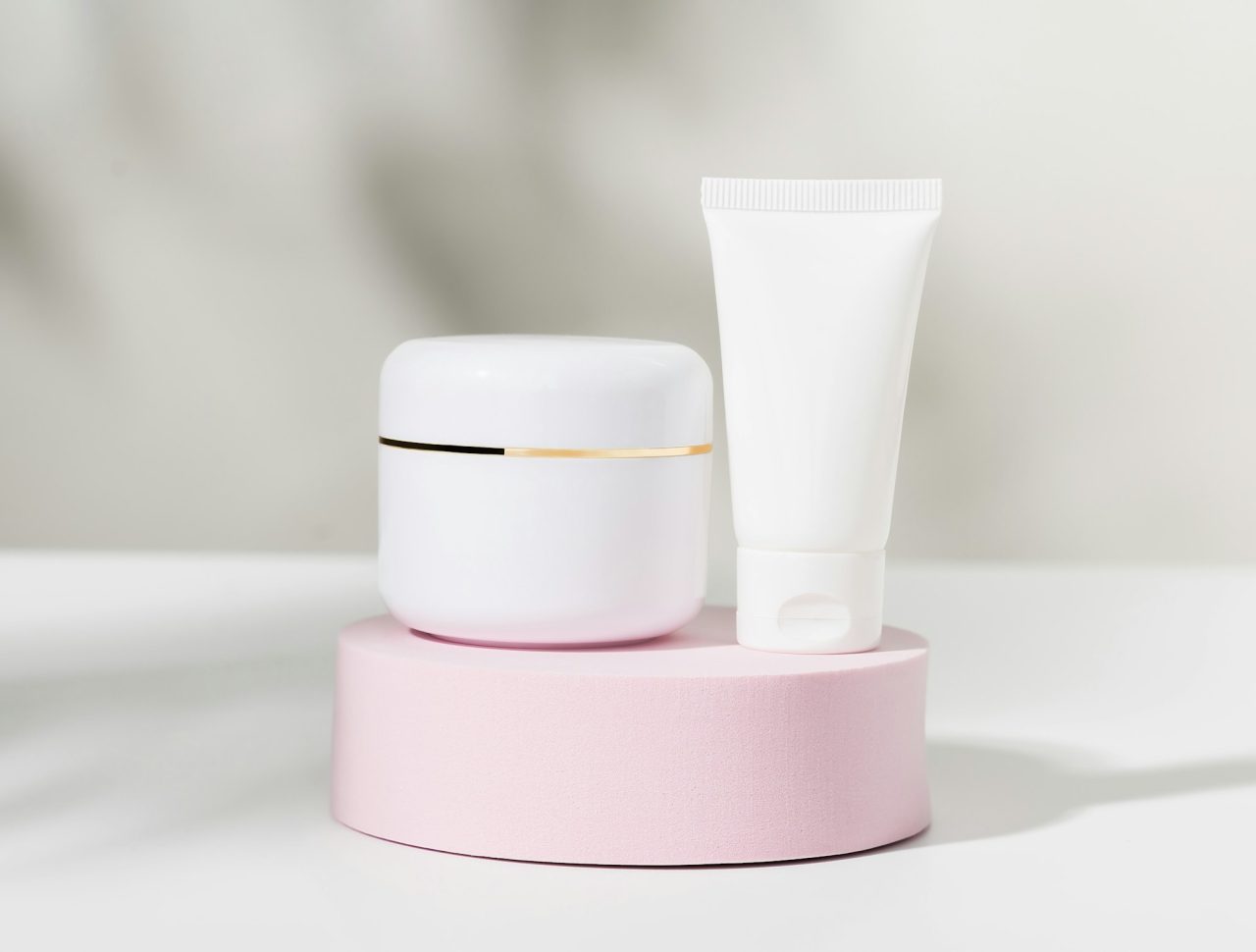White cosmetic bottle on podium ingredients for skin care packaging product for mockup .jpg